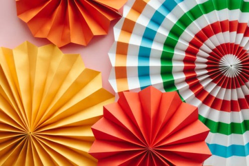 colorful paper fans, party and home wall and window decorations, festive paper trendy background for holidays and celebrations. - home decoration stock pictures, royalty-free photos & images