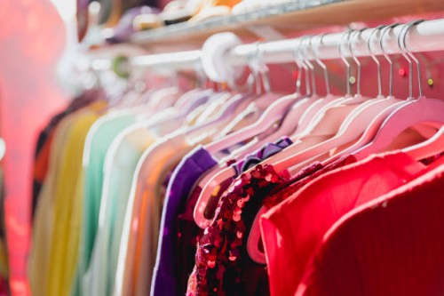 colorful vibrant clothing rack at a thrift store - fashion stock pictures, royalty-free photos & images