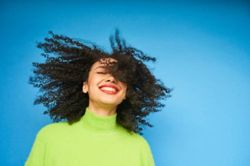 colourful studio portrait of a young woman dancing - hairstyle stockfoto's en -beelden