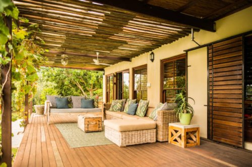 comfortable sofa on a patio outside on a sunny afternoon - garden decoration stock pictures, royalty-free photos & images