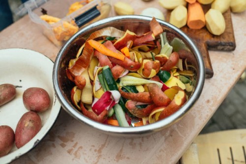 compost bin with vegetables leftovers at an open kitchen outdoors at back yard. sustainable lifestyle and zero waste cooking concept. - food stock pictures, royalty-free photos & images