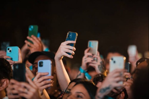 Concert-goers use their smartphones during Daniel Caesar concert during the C6 Fest at Parque Ibirapuera on May 19, 2024 in Sao Paulo, Brazil.