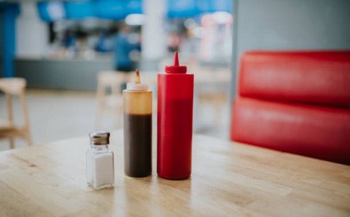 condiment bottles on a table in a diner - junk food stock pictures, royalty-free photos & images