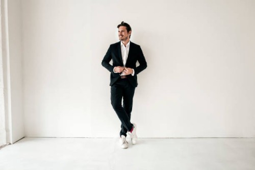 confident businessman standing in empty room - fashion stock pictures, royalty-free photos & images