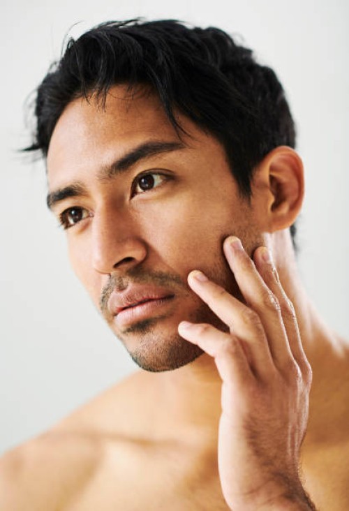 confident, calm and serious handsome male model with clear skin. portrait of a young man with a good skincare routine and a clean face. guy with smooth and glowing skin after shaving - fashion stock pictures, royalty-free pho