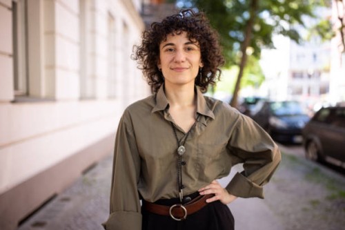 confident non-binary person standing with hand on hip outdoors - fashion stock pictures, royalty-free photos & images