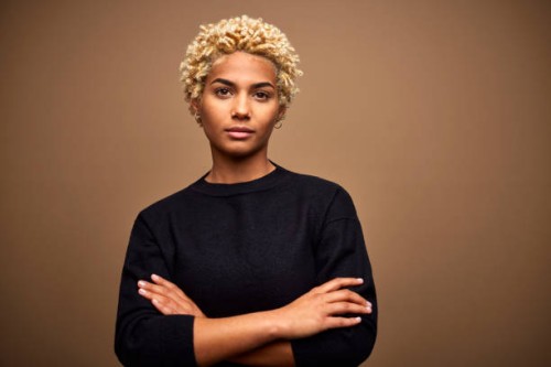 confident young female afro owner against brown background - fashion stock pictures, royalty-free photos & images