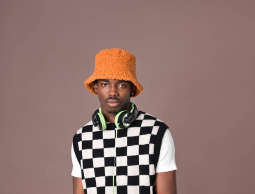 confident young man against brown background - fashion stock pictures, royalty-free photos & images