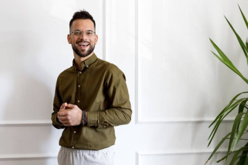 confident young man in casual green shirt looking away - fashion stock pictures, royalty-free photos & images
