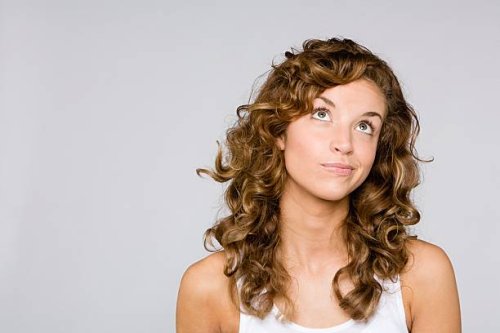 confused looking woman - hairstyle stock pictures, royalty-free photos & images