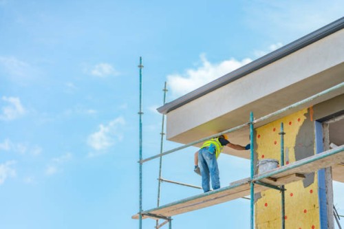 construction worker applying plaster on building facade - home decoration stock pictures, royalty-free photos & images
