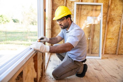 construction worker installing windows on wooden house - home decoration stock pictures, royalty-free photos & images