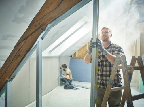 construction worker measuring metal for drywall at site - home decoration stock pictures, royalty-free photos & images