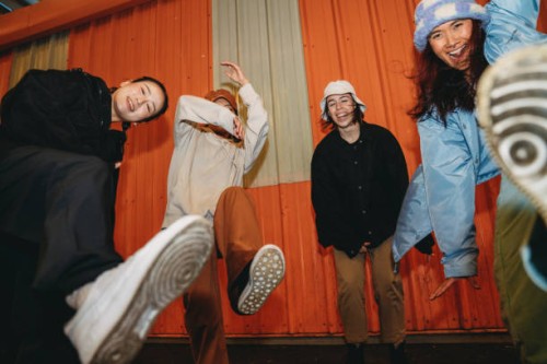 cool dancers are having fun dancing against an orange wall - fashion stock pictures, royalty-free photos & images