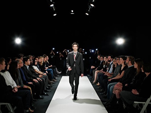 cool geek walking down runway at fashion show - fashion stock pictures, royalty-free photos & images