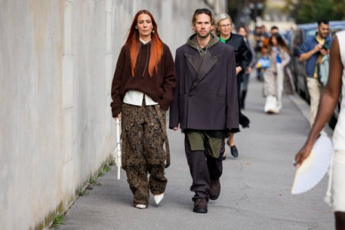 Couple Alice Barbier wears hoody, camouflage pants & Sebastian Roques wears oversized blazer outside Givenchy during the Womenswear Spring/Summer...