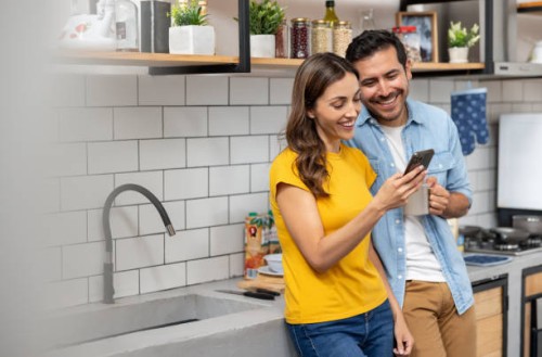 couple at home looking at social media on their cell phone - food stock pictures, royalty-free photos & images