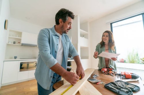 couple at home working together on a diy project - home decoration stock pictures, royalty-free photos & images