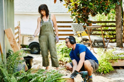 couple building raised garden beds in backyard on summer afternoon - home decoration stock pictures, royalty-free photos & images