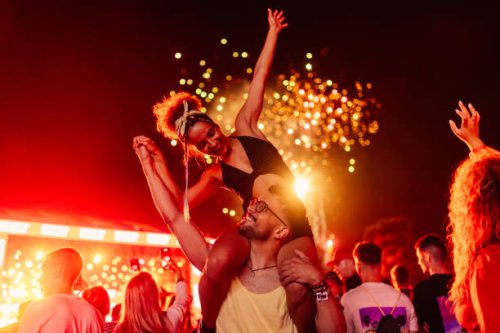 couple celebrating with fireworks - concert stock pictures, royalty-free photos & images