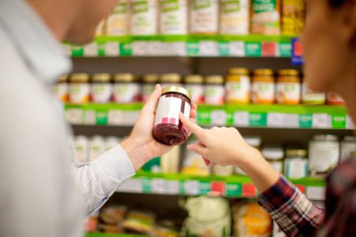 couple choosing jar of jam - food stock pictures, royalty-free photos & images