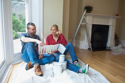 couple choosing paint colors in new home - home decoration stock pictures, royalty-free photos & images