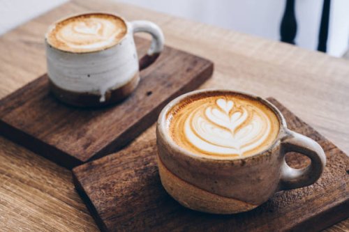 couple cup of latte coffee on wooden table. - coffee stockfoto's en -beelden