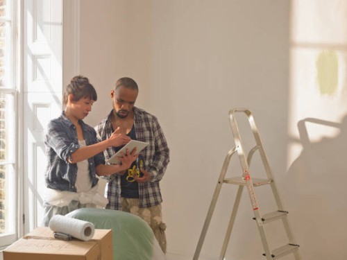 couple doing diy looking at a tablet computer - home decoration stock pictures, royalty-free photos & images