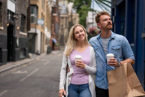 couple doing some shopping and drinking coffee - junk food stock pictures, royalty-free photos & images