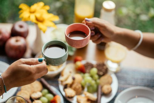 couple drinking coffee together over breakfast on the patio of a bnb - coffee stock pictures, royalty-free photos & images