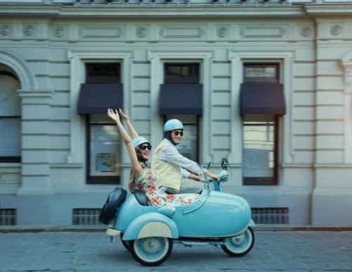 couple driving vintage scooter and sidecar - travel stockfoto's en -beelden