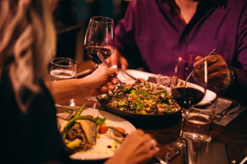 couple eating quinoa salad and healthy dinner at restaurant - food stock pictures, royalty-free photos & images