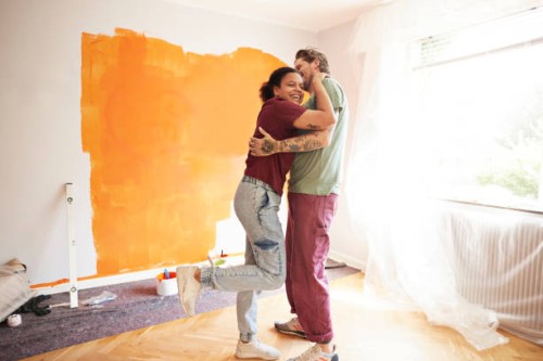 couple embracing at home during renovation - home decoration stock pictures, royalty-free photos & images