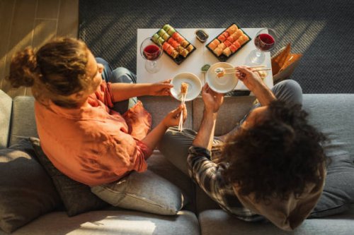 couple enjoying assorted sushi home delivery. - junk food stock pictures, royalty-free photos & images