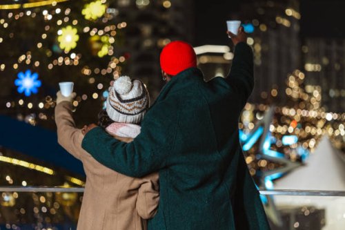 couple enjoying outdoor winter festival at night with colorful lights - concert stock pictures, royalty-free photos & images