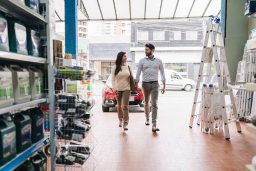 couple entering a construction material store - home decoration stock pictures, royalty-free photos & images
