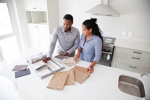 couple examining fabric swatches in new home - home decoration stock pictures, royalty-free photos & images