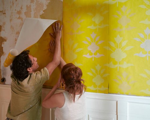 couple hanging wallpaper - home decoration stock pictures, royalty-free photos & images