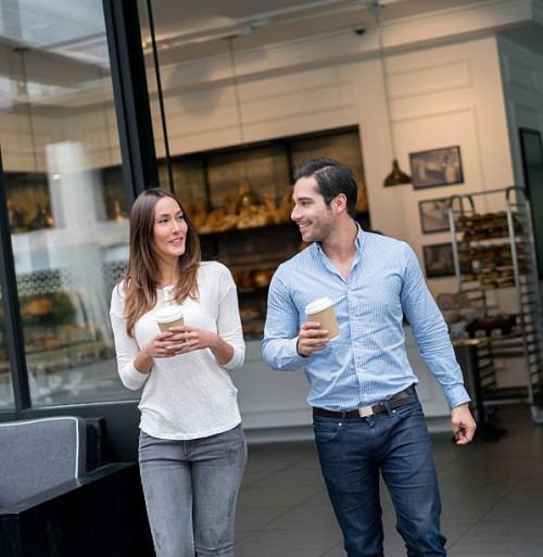 couple having a cup of coffee on the go - junk food stock pictures, royalty-free photos & images