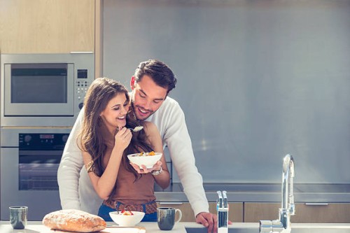 couple having fun eating breakfast. - food stock pictures, royalty-free photos & images