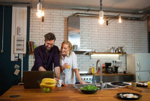 couple in the kitchen using laptop - home decoration stock pictures, royalty-free photos & images