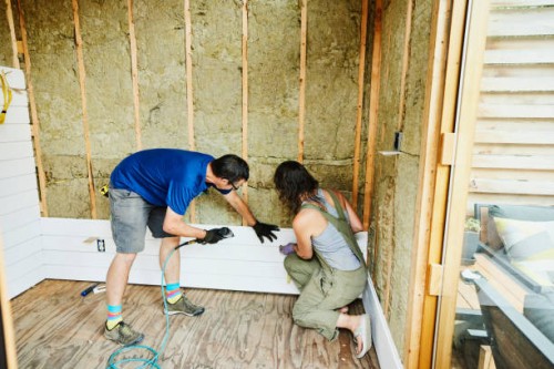 couple installing siding during home improvement project - home decoration stock pictures, royalty-free photos & images