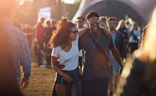 couple laughing together at big festival - concert stock pictures, royalty-free photos & images
