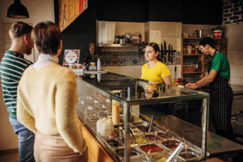 couple looking what to eat - junk food stock pictures, royalty-free photos & images
