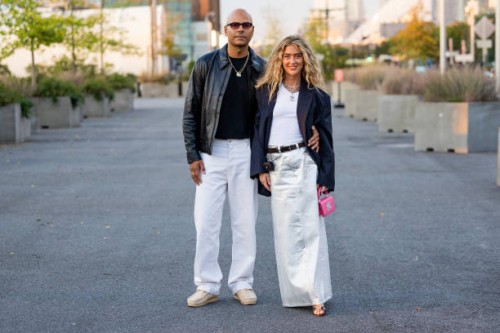 Couple Mads Emil & Emili Sindlev wears silver white skirt, black blazer, pink bag, white shirt wears outside COS on September 12, 2023 in New York...