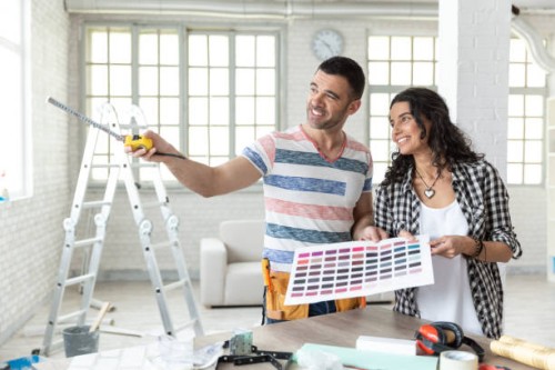 couple making home improvement and using laptop - home decoration stock pictures, royalty-free photos & images