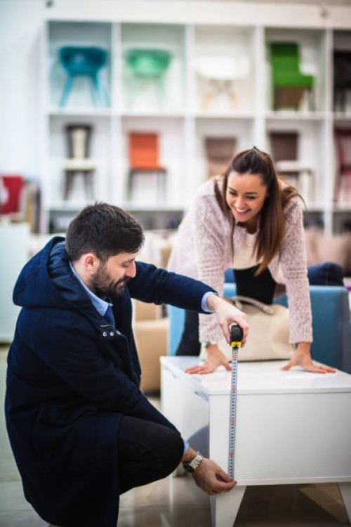 couple measuring in furniture shop - home decoration stock pictures, royalty-free photos & images