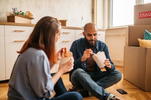 couple moving into new home enjoying takeaway food - junk food stock pictures, royalty-free photos & images