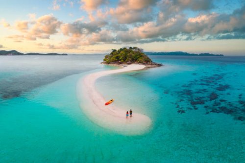 couple on idyllic tropical sandbar at sunset - travel stock pictures, royalty-free photos & images