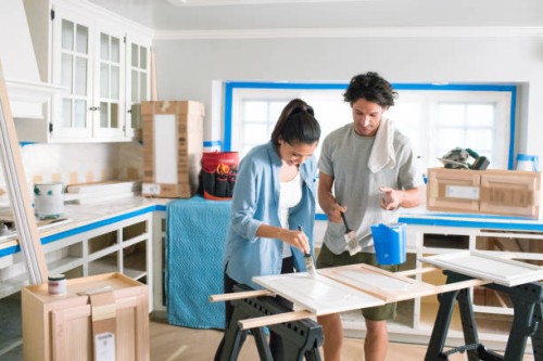 couple painting and fixing up their home - home decoration stock pictures, royalty-free photos & images